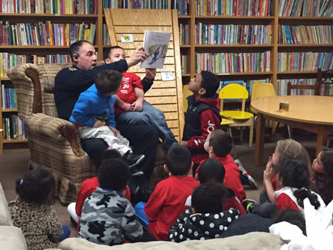 Police Officers Read to Visitors